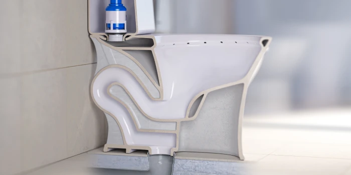 Parts of a toilet with bowl cutout to show internal mechanisims.