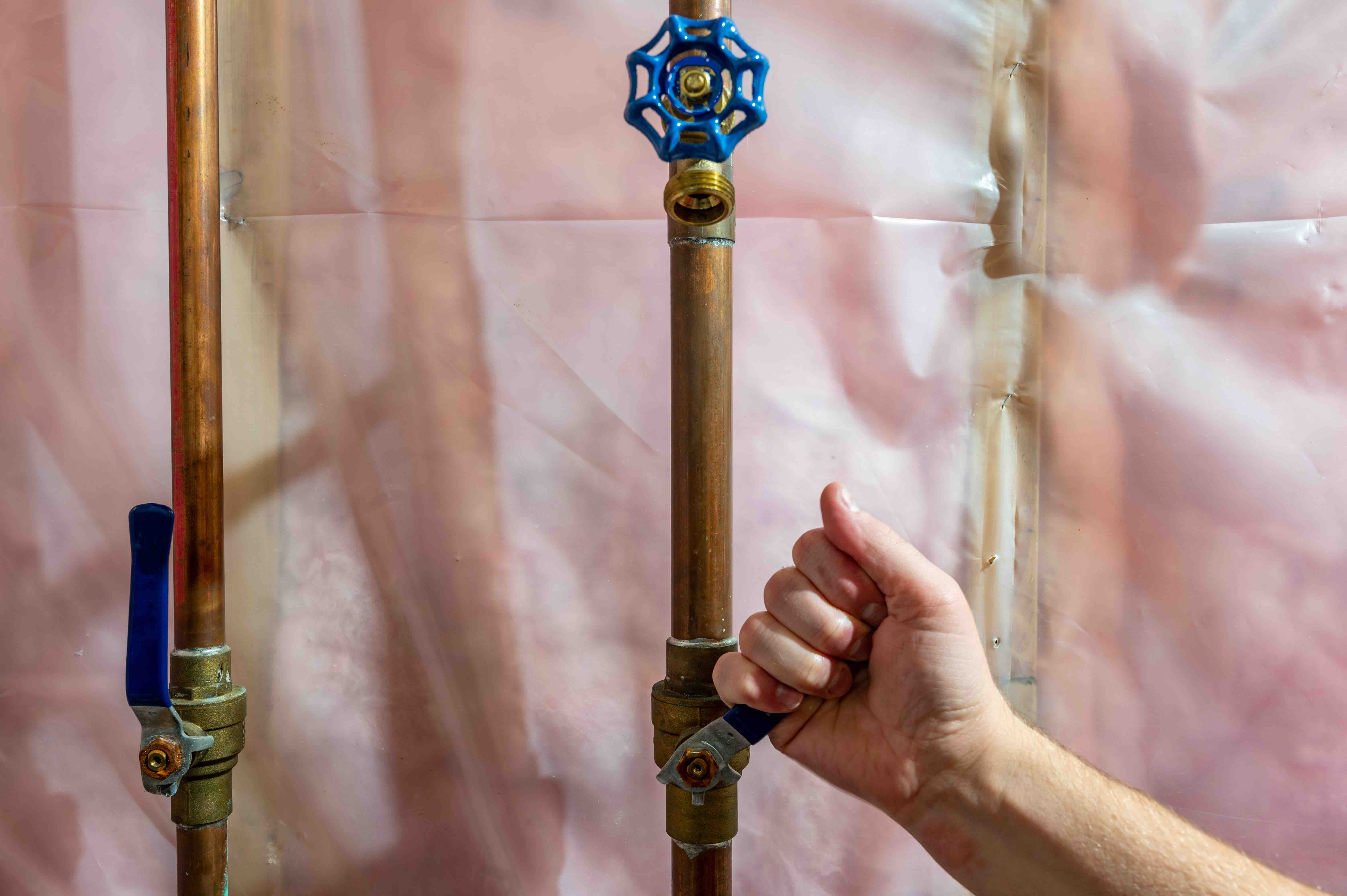 Hand pulling lever for water shutoff inside a basement.